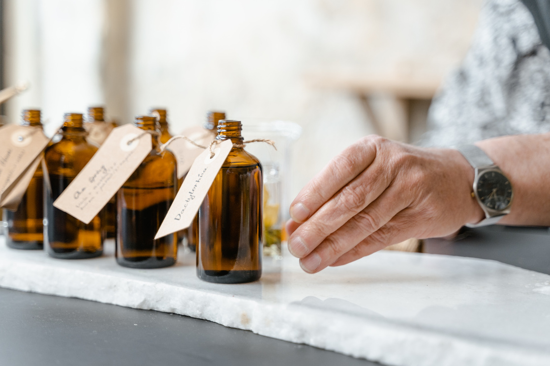 A Person Reaching for a Perfume Bottle